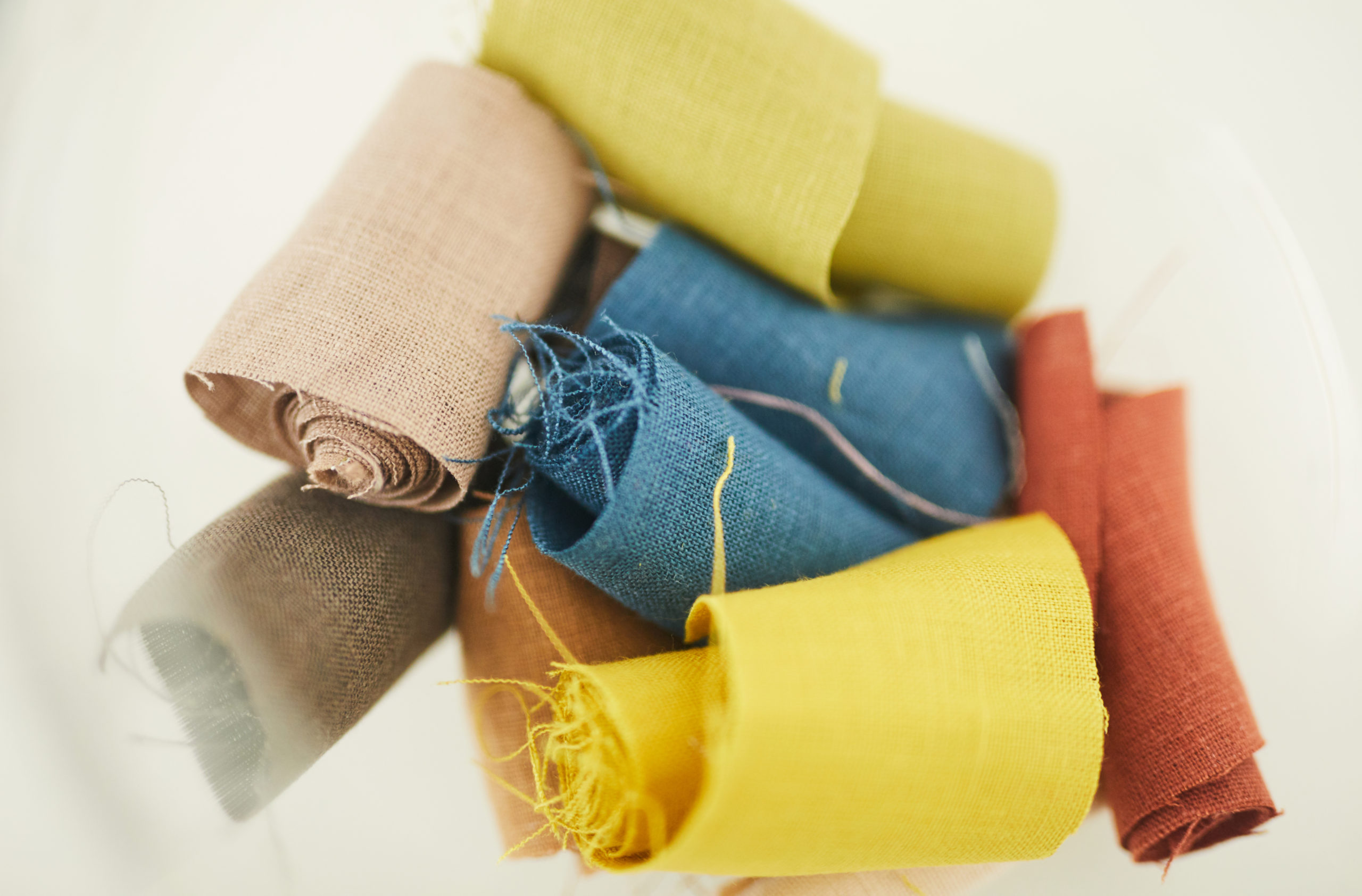 Close-up of colored scraps of fabric isolated on white background